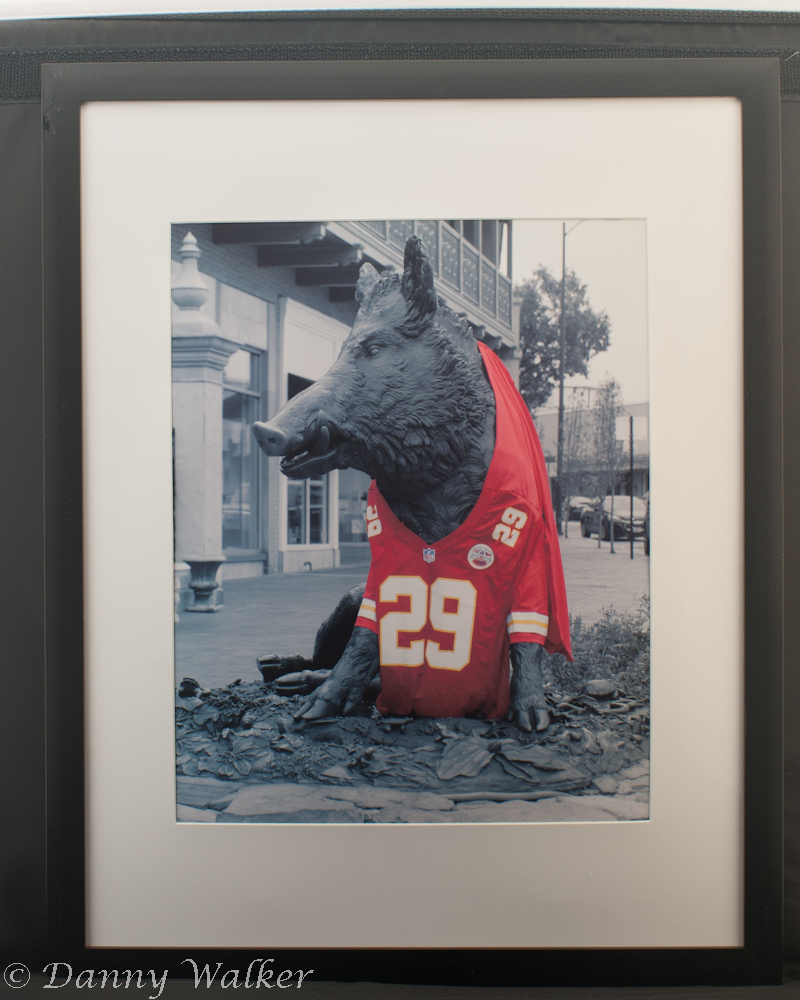 A statue of a wild boar wearing a Kansas City Chiefs football jersey.