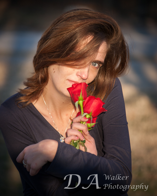 Woman's protrait with flowers to her nose.